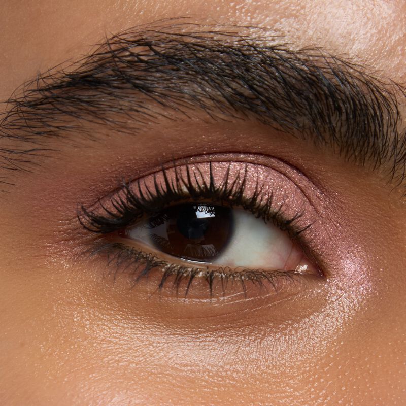 Medium skinned model wearing Mary kay Eye Shadow Sticks in shades Pink Prisms and Lunar Rose